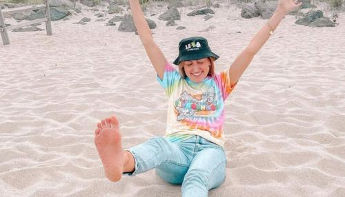 women wearing a tie dye shirt on the beach